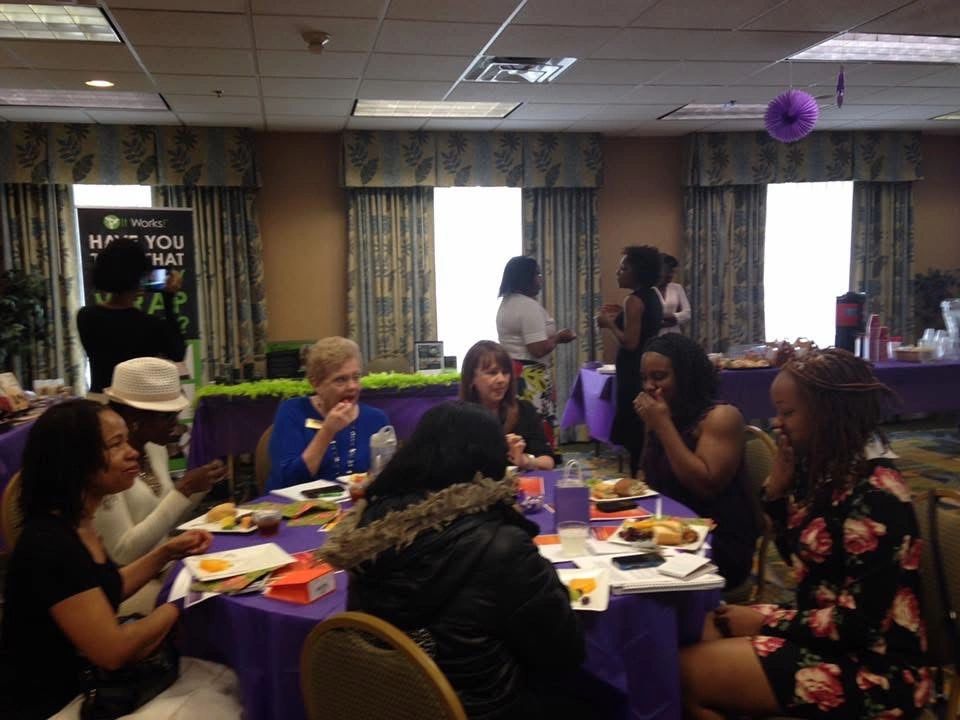 Women in conversation around a workshop table