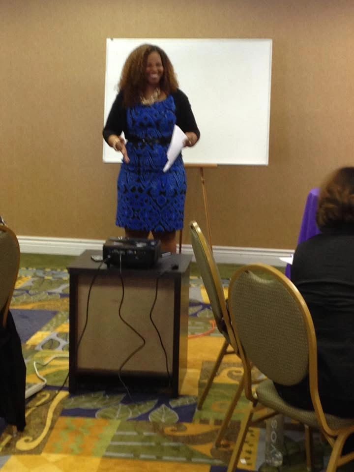 Kat speaking at the front of a room