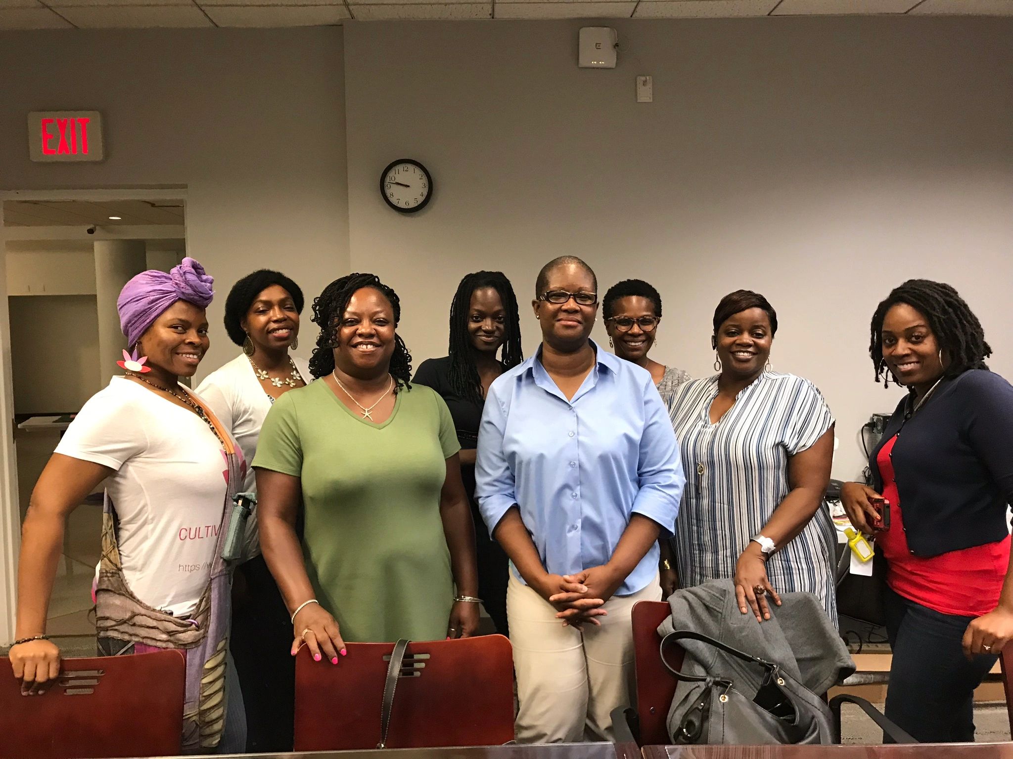 Women gathered around Kat after a workshop